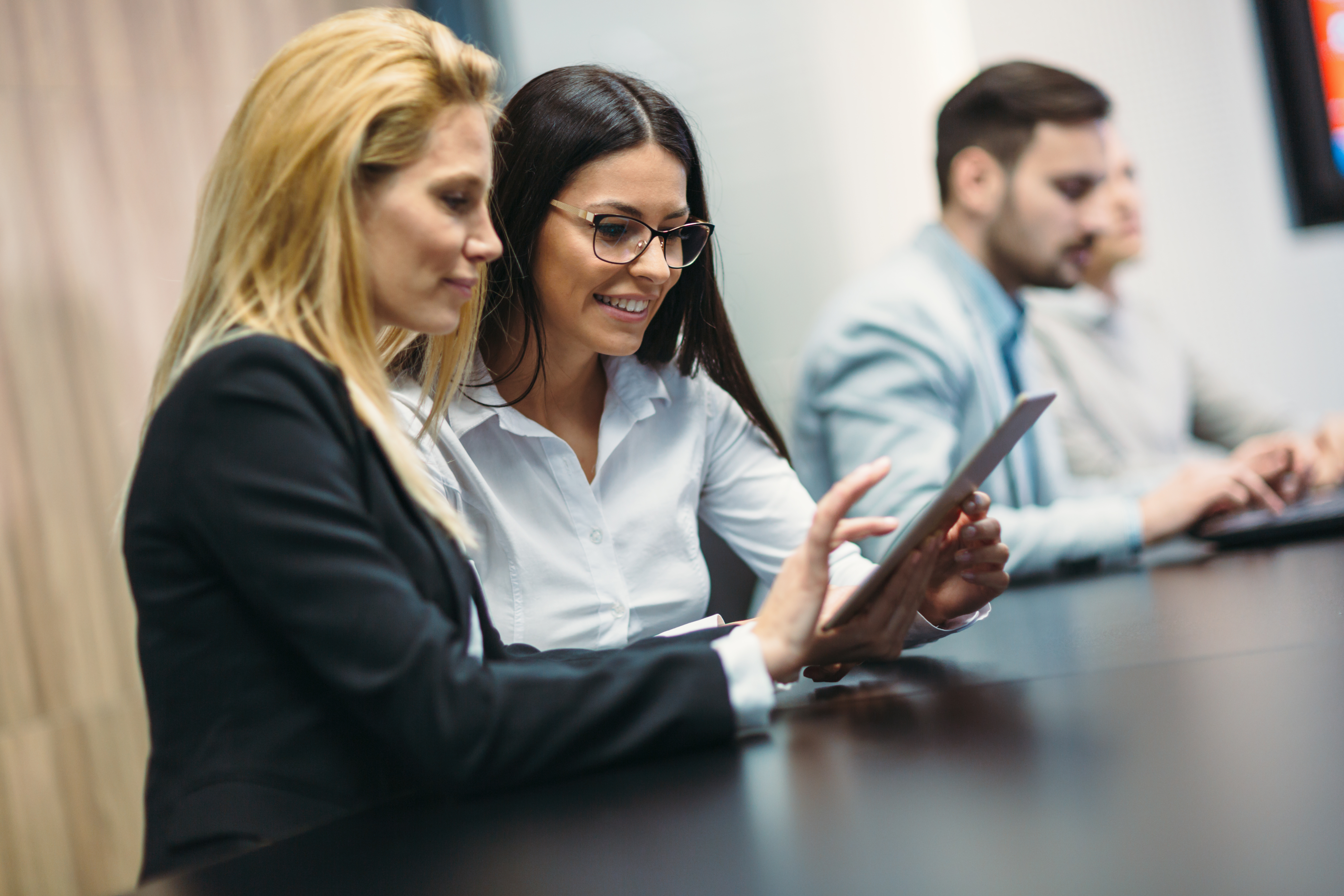 portrait-of-two-attractive-businesswomen-using-tab-2025-03-14-01-00-06-utc-1